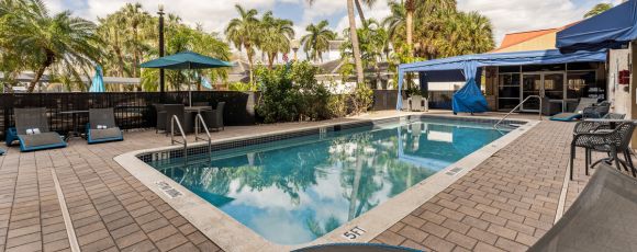 Outdoor pool at the Hampton Inn & Suites Fort Lauderdale, showcasing a relaxing atmosphere for guests.