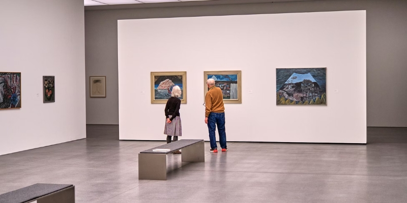 A couple explores artwork at the NSU Art Museum, enjoying a cultural experience in Fort Lauderdale together.