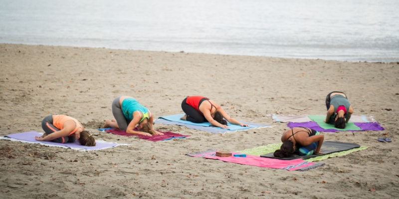Yoga session on the beach at Dania Beach Pier, emphasizing a peaceful atmosphere and connection with nature.