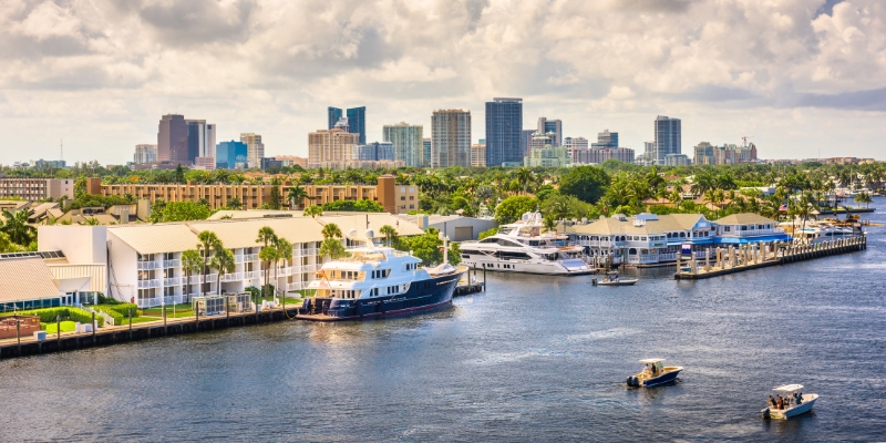 View of Miami skyline from the water, showcasing tall buildings against a clear sky, featured in Fort Lauderdale activities.