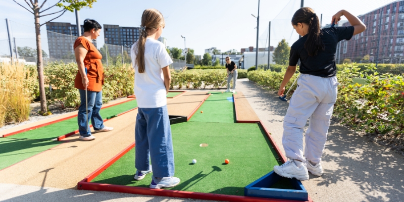 A group of children engaged in mini golf at C.B. Smith Park, showcasing family activities in Fort Lauderdale.