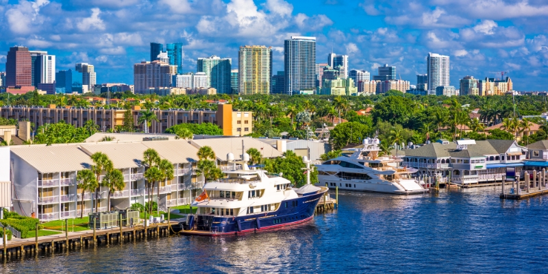 A scenic view of Fort Lauderdale's skyline from the water, showcasing downtown buildings against a clear sky.