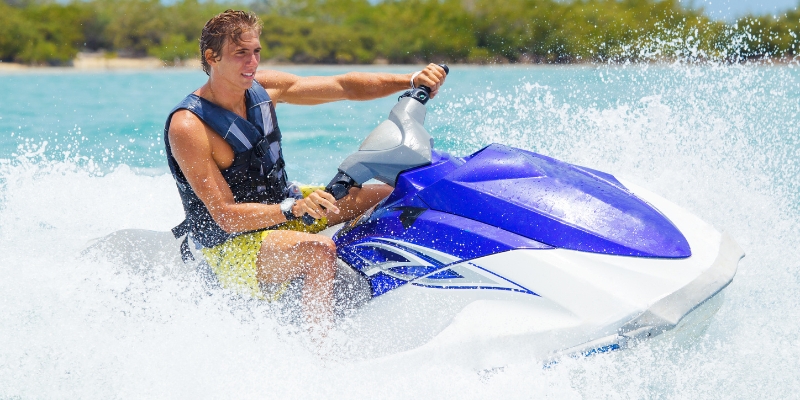 A man enjoying a jet ski ride in the ocean at Fort Lauderdale Beach, highlighting water sports opportunities.
