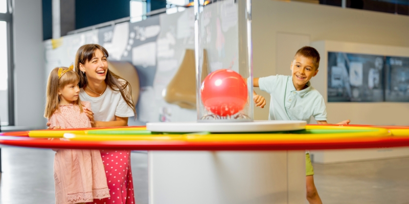 Kids engage in playful activities with a bright ball at the Museum of Discovery & Science in Fort Lauderdale.