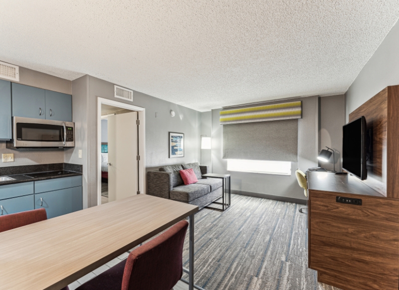 A cozy hotel room featuring a small kitchen and living area at Hampton Inn & Suites Ft. Lauderdale near Dania Pointe.