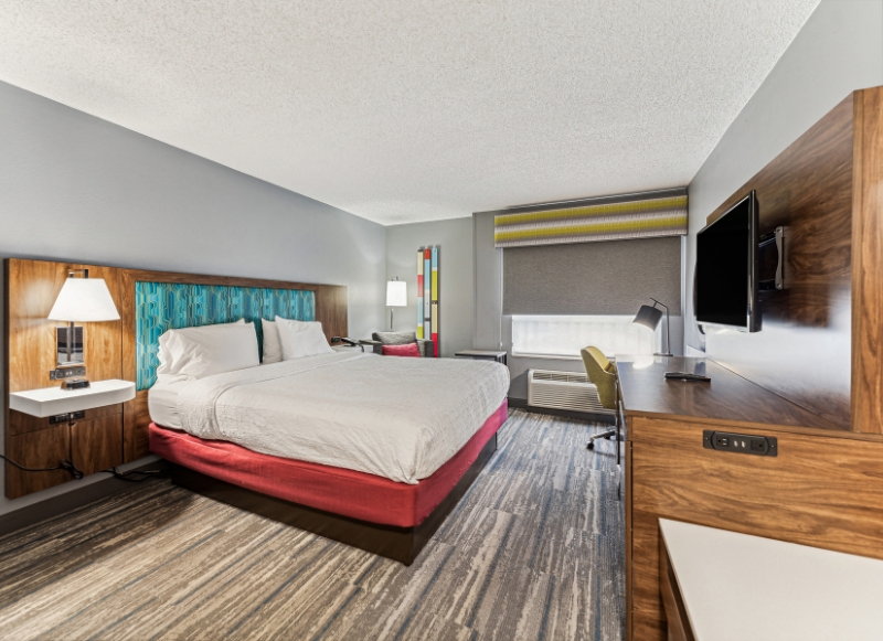 Comfortable hotel room with a bed, desk, and TV, located at Hampton Inn & Suites Ft. Lauderdale near Dania Pointe.